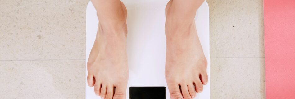 person standing on white digital bathroom scale