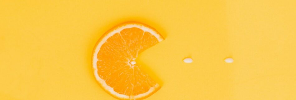 orange fruit on yellow surface