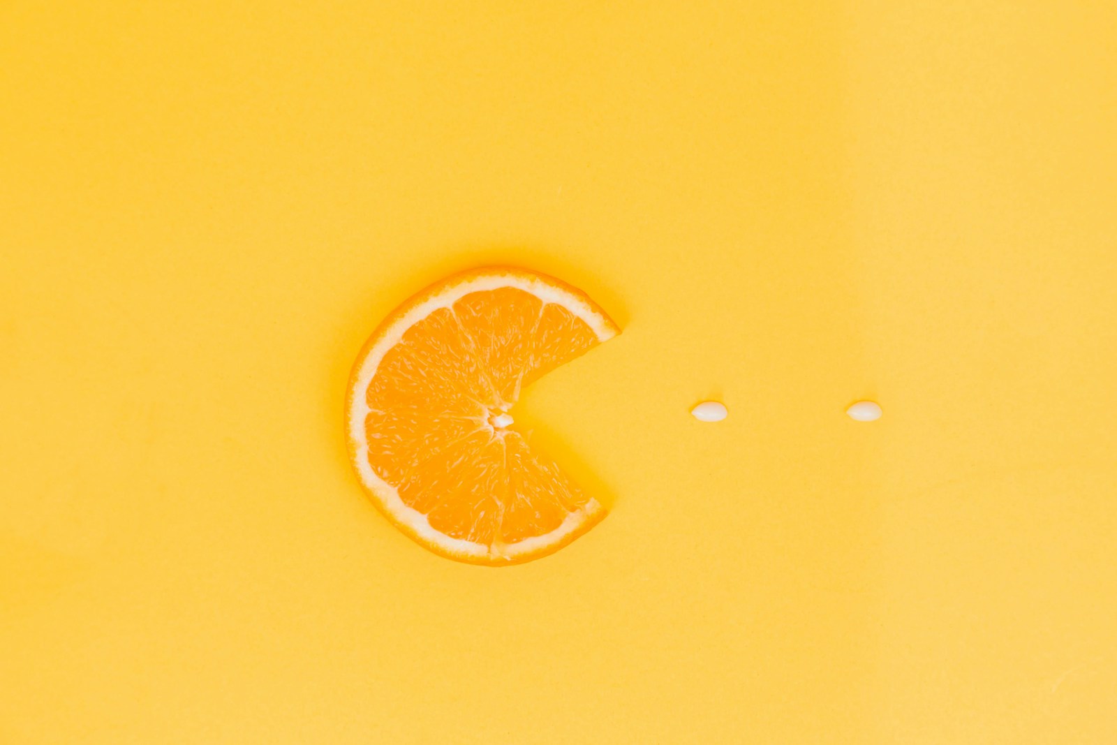 orange fruit on yellow surface