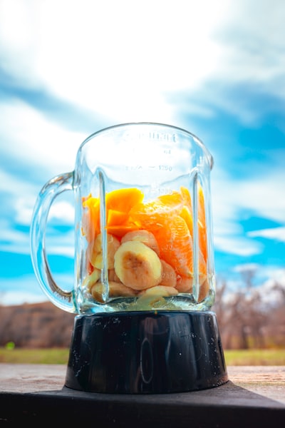 clear glass mug with black liquid inside